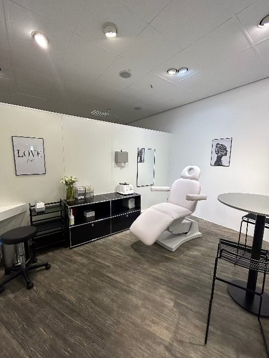 Behandlungsraum bei MYH&B mit Liege, Spiegel, Blumen und stilvoller Deko